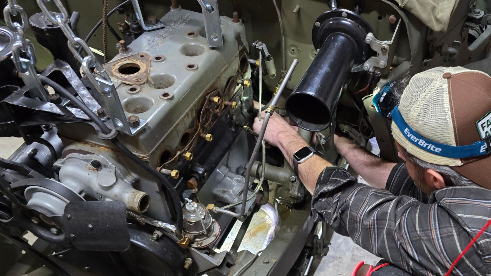 Friend working on WW2 Jeep during repairs – example of community support and camaraderie